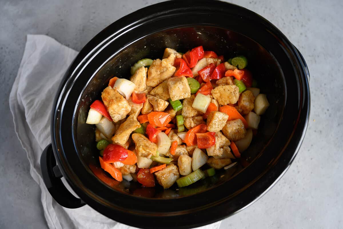 chicken, vegetables and sauce in a crockpot