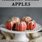 healthy baked apples drizzled with sweet yogurt sauce, pecans and cinnamon on a cake pedestal