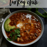 bowl of healthy turkey chili garnished with cilantro and avocado