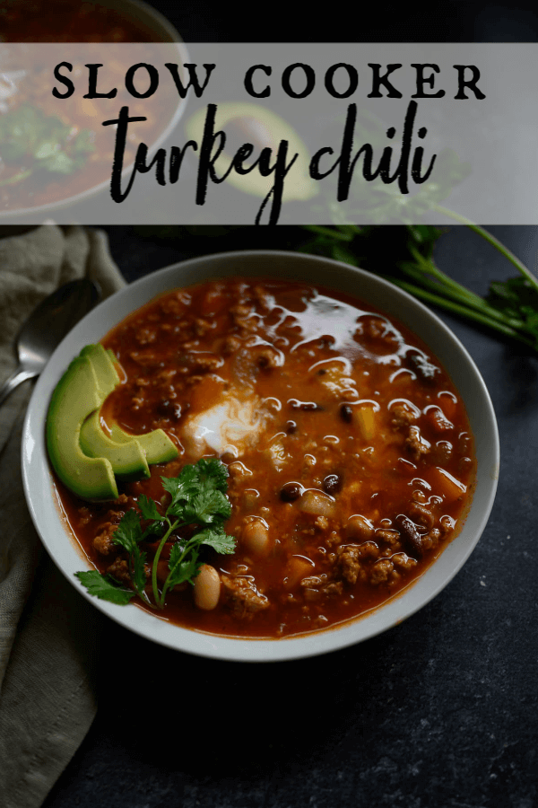 Made with ground turkey, this healthy turkey chili still is a bowl full of comfort! Whether you need an easy weeknight meal, you're entertaining, or you need something for the big game, this slow cooker turkey chili is a show stopper. #crockpot #turkeychili #gameday via @artfrommytable