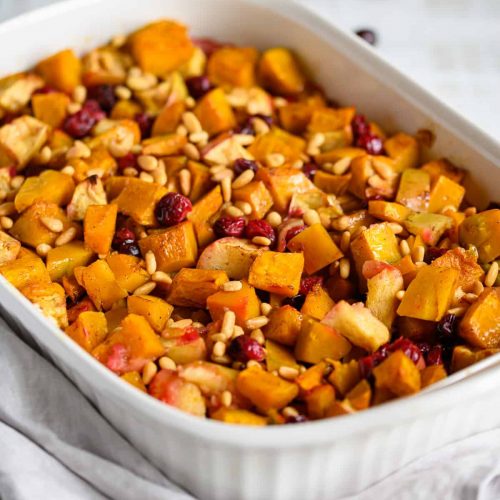 squash apple cranberry bake topped with toasted pine nuts