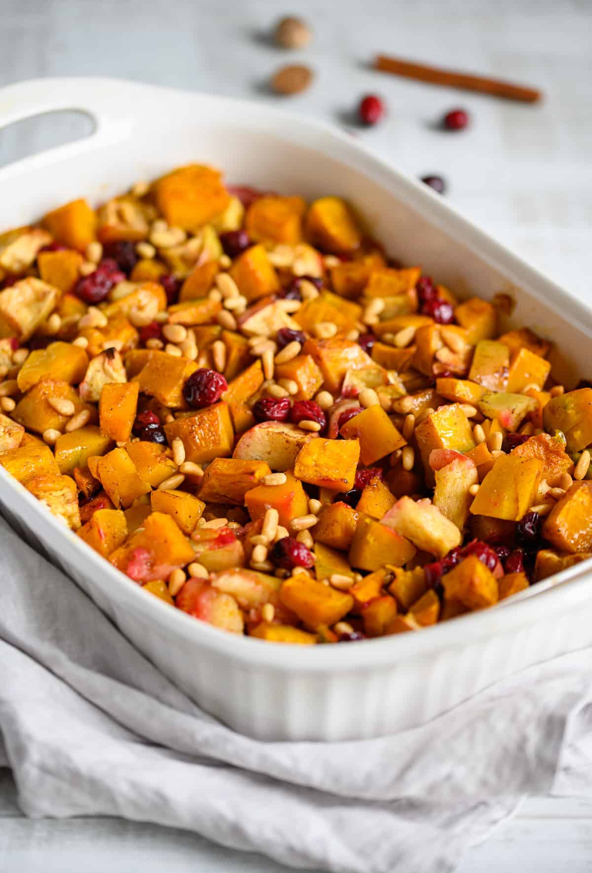 squash apple cranberry bake topped with toasted pine nuts