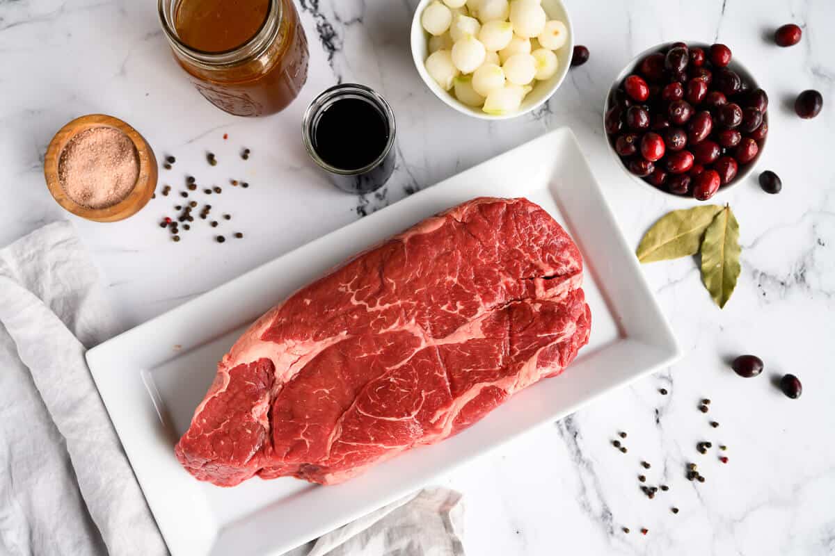 ingredients for braised beef, chuck roast, cranberries, onions, wine, broth