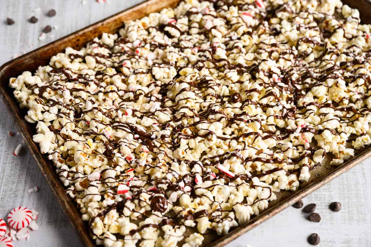 tray of popcorn drizzled with chocolate and crushed peppermint