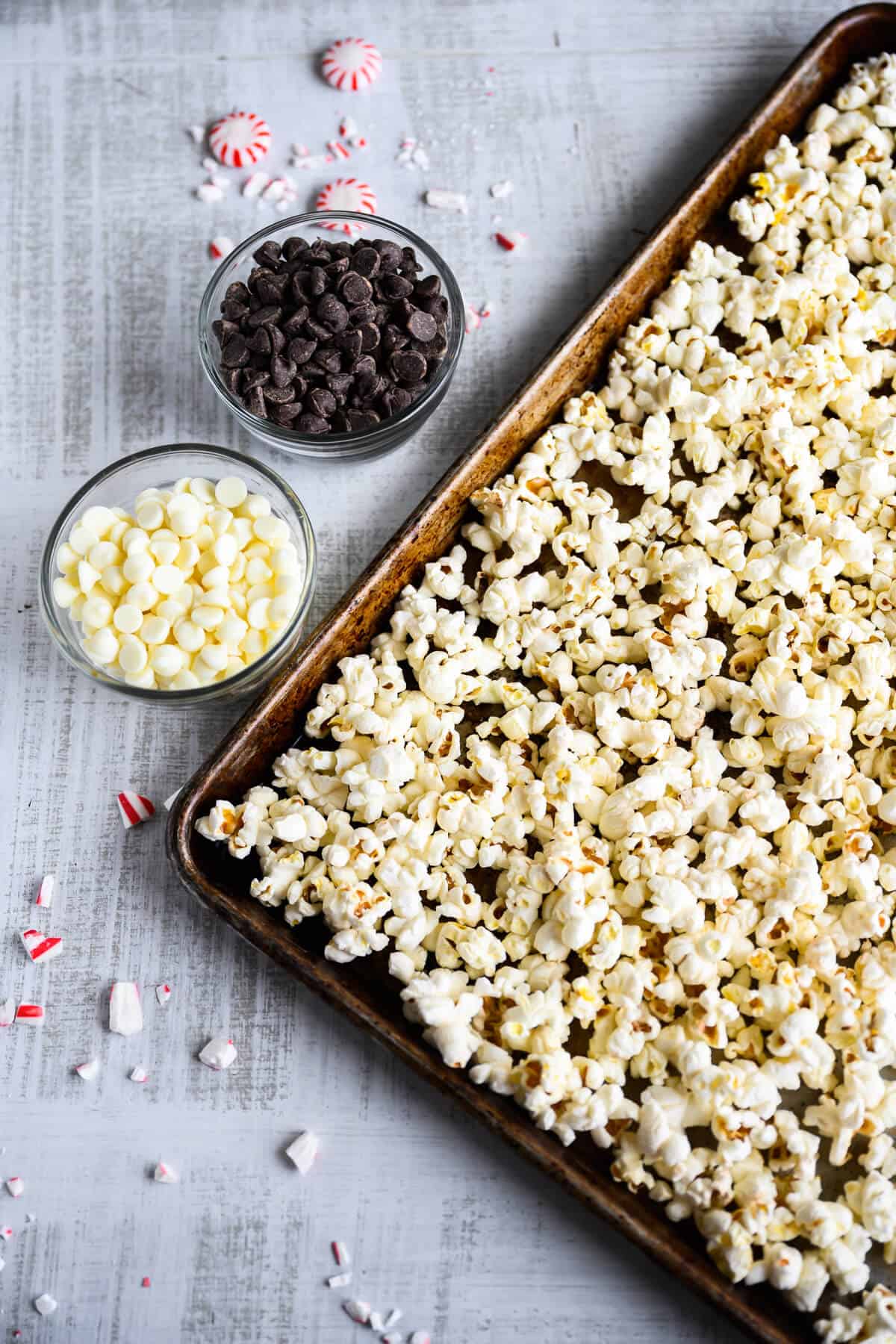 pepprmints, dark and white chocolate chips next to a tray of popcorn