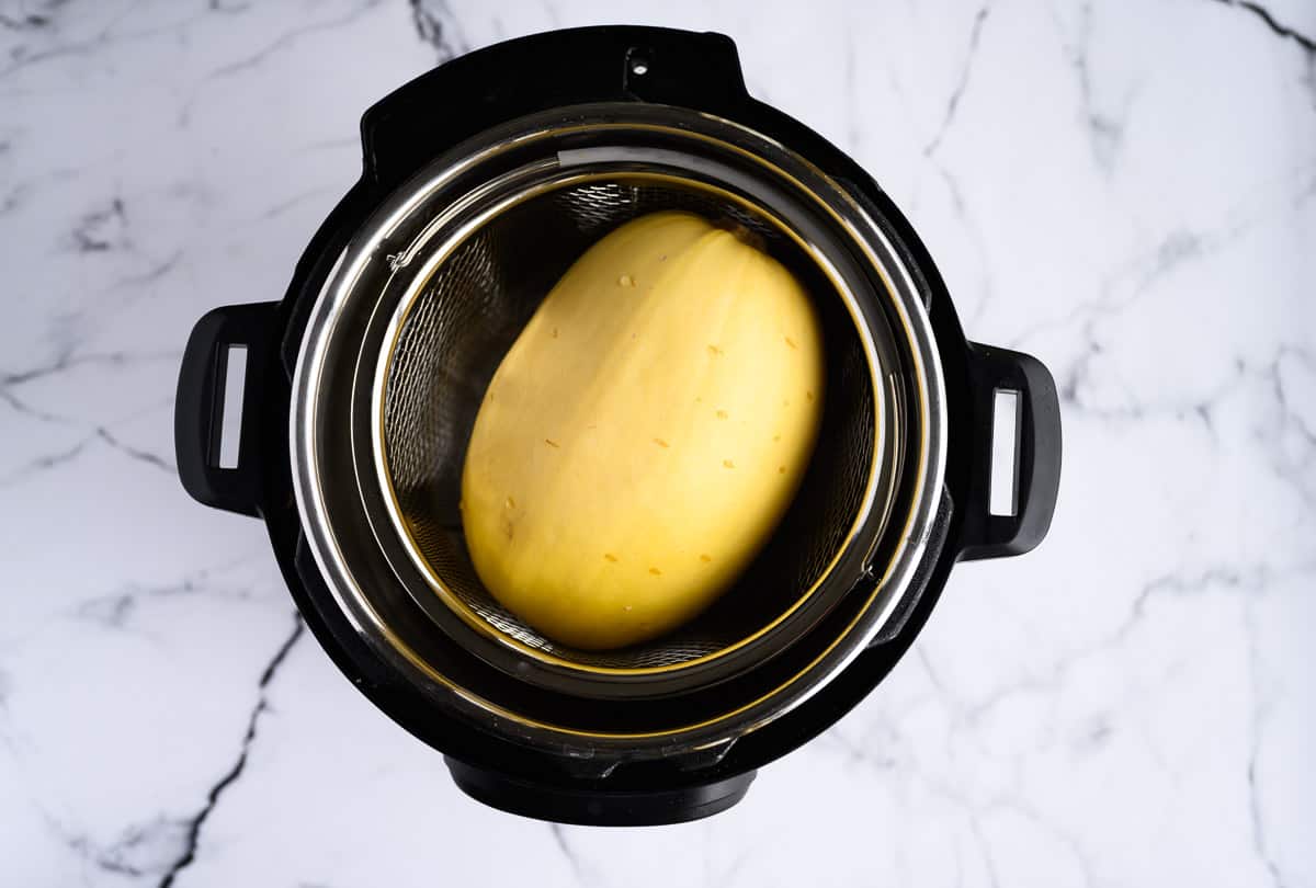whole spaghetti squash inside an electric pressure cooker
