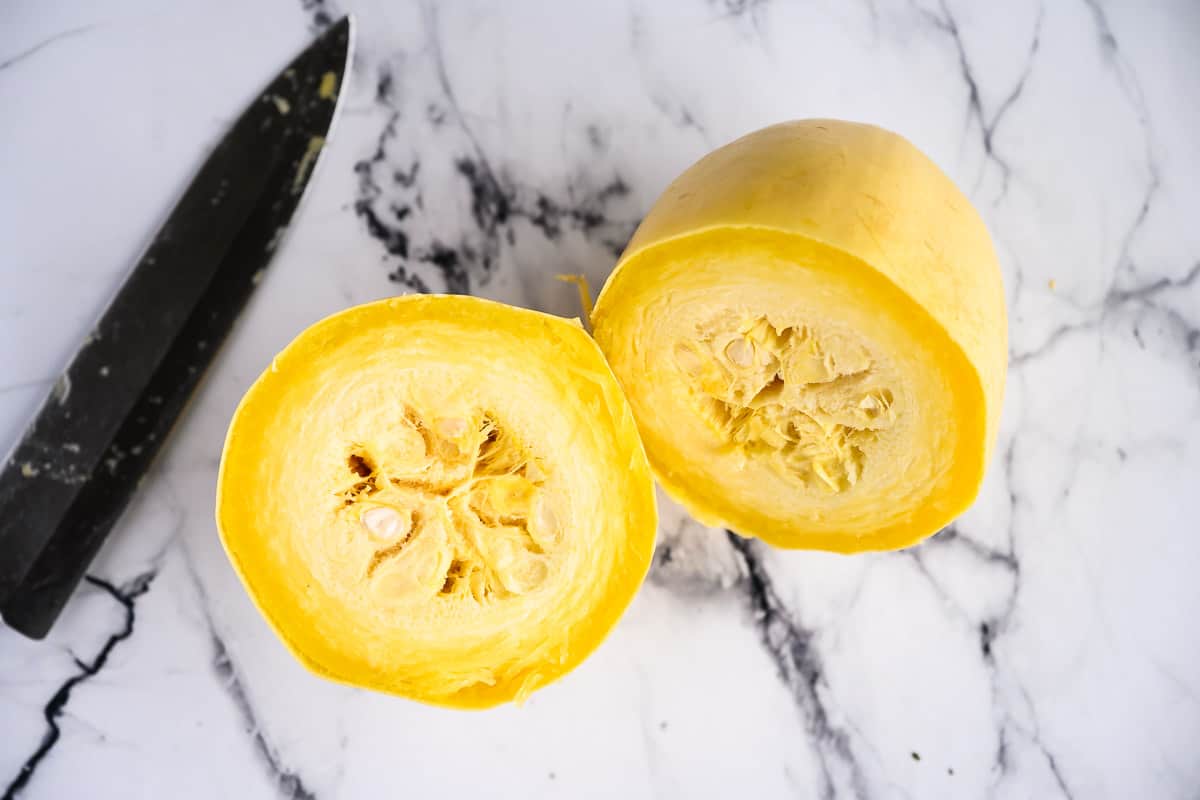 one cooked spaghetti squash split in half, seeds still in tact