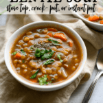 bowl of lentil soup, garnished with parsley and pepper.