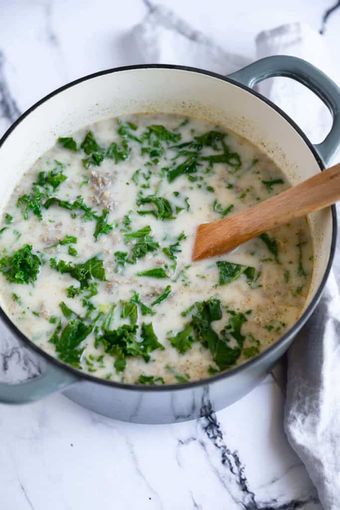 dutch oven full of sausage and kale soup