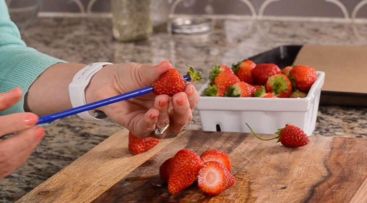 hulling a strawberry with a straw
