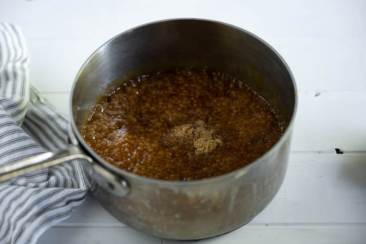 gingerbread spices being added to caramel sauce