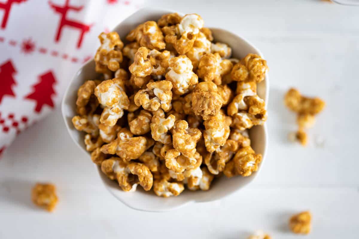 homemade caramel corn in a white dish