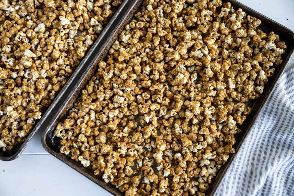 gingerbread caramel corn cooling on a rimmed baking sheet