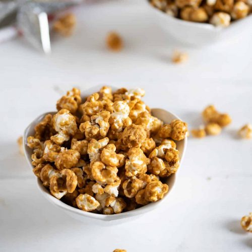 homemade gingerbread caramel corn in a white bowl