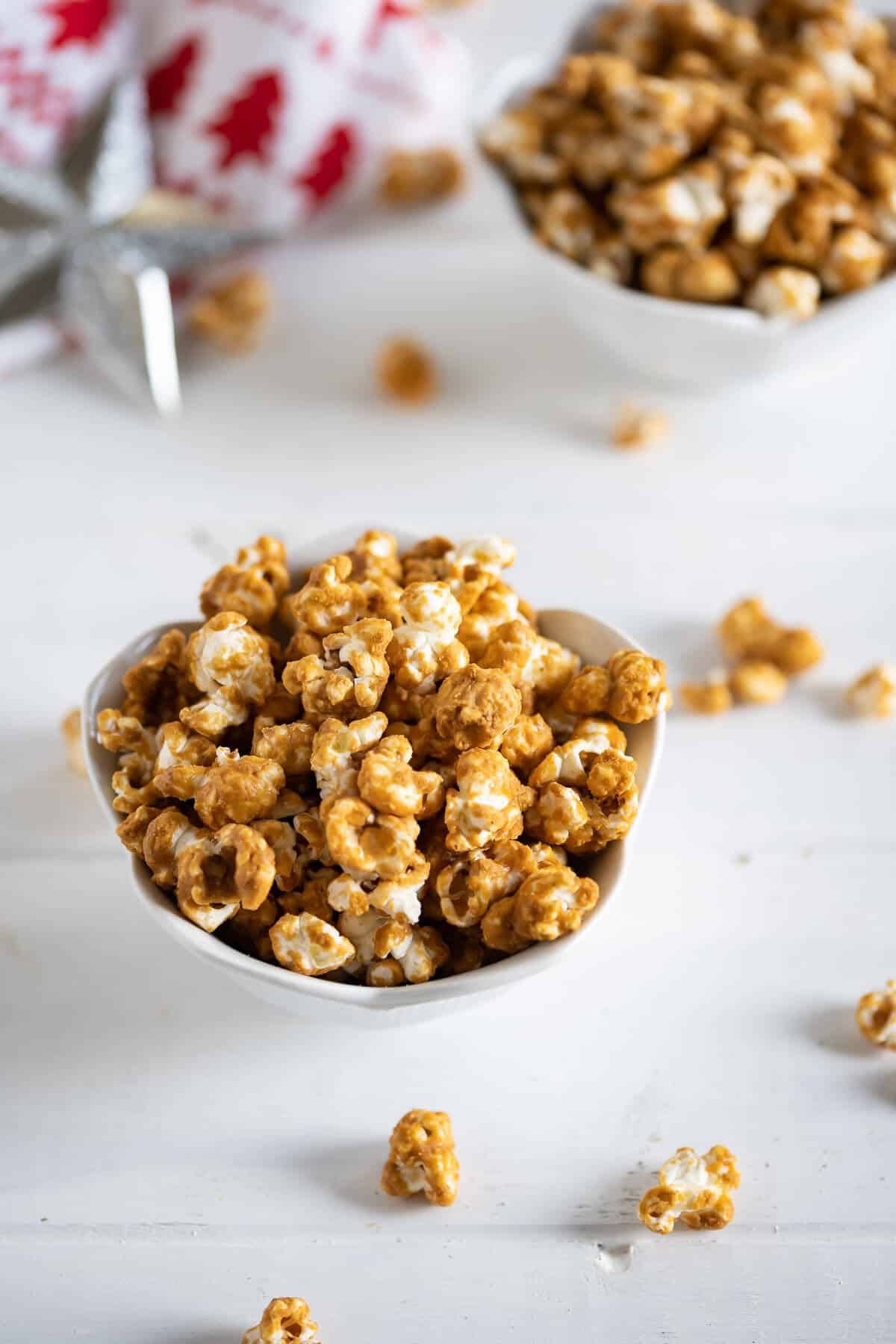 homemade gingerbread caramel corn in a white bowl
