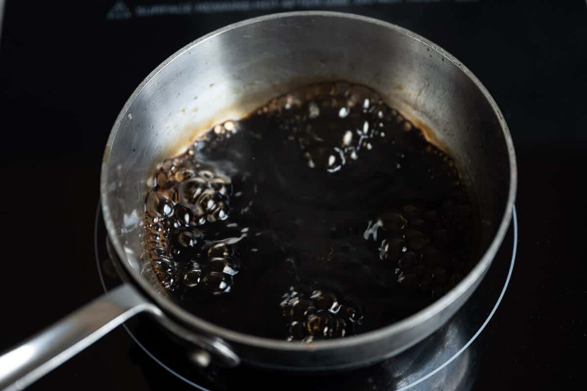 balsamic vinegar and pomegranate juice boiling in a pan