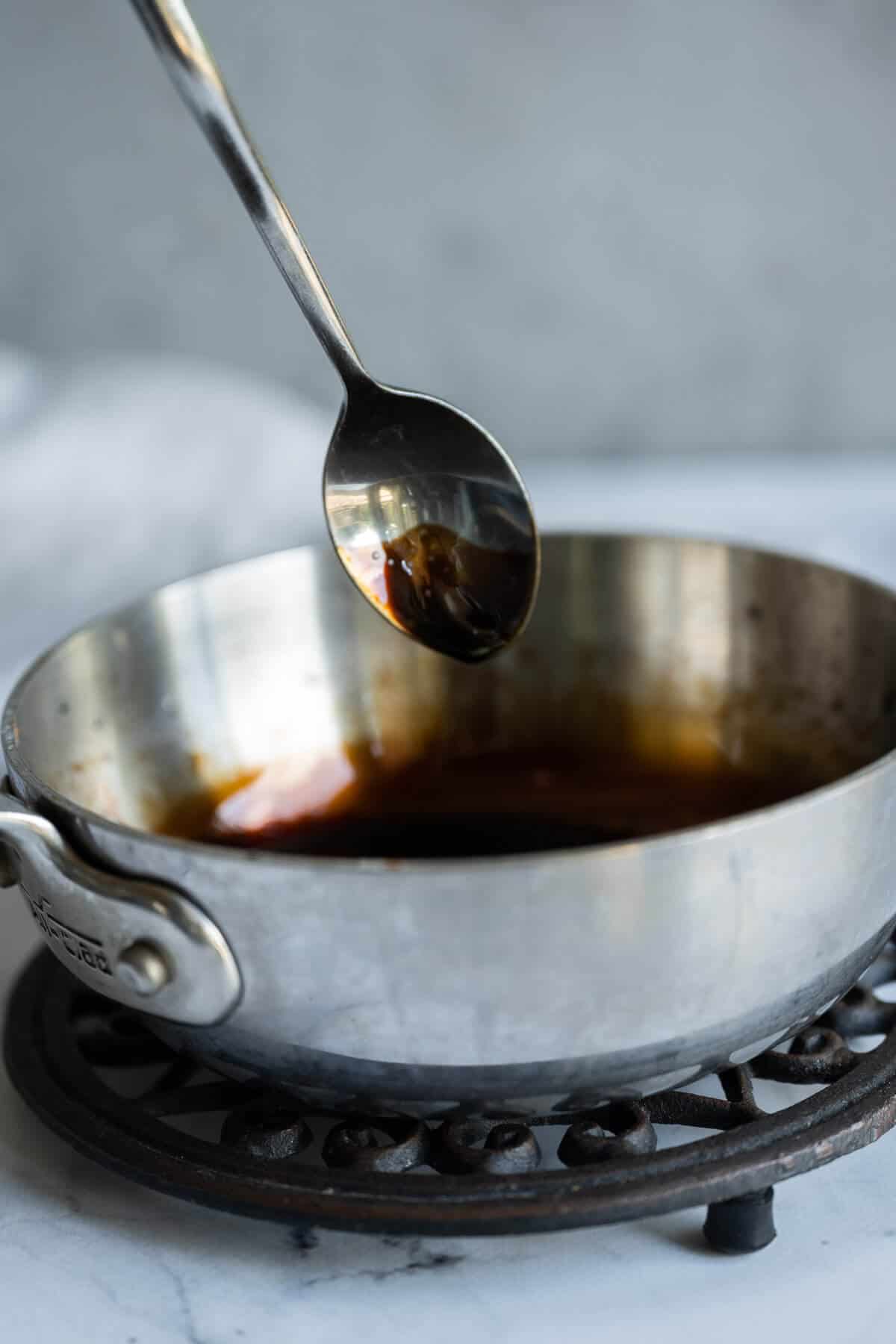balsamic reduction dripping off spoon