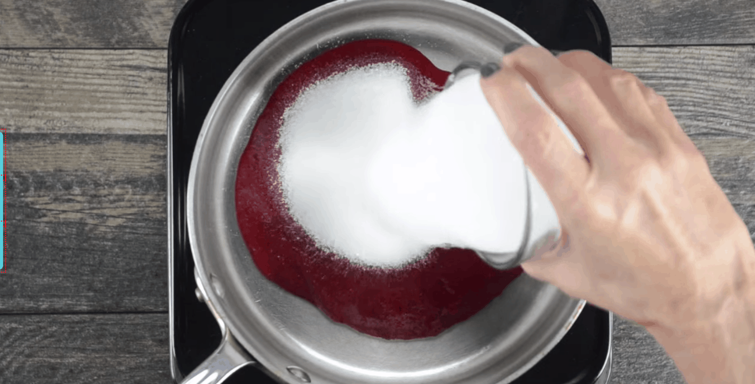 sugar being added to homemade cranberry sauce