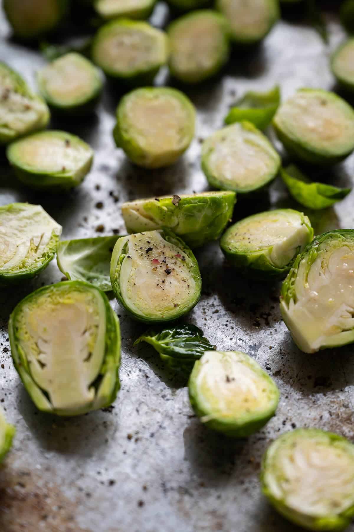 raw brussels sprouts seasoned with olive oil, salt, and pepper