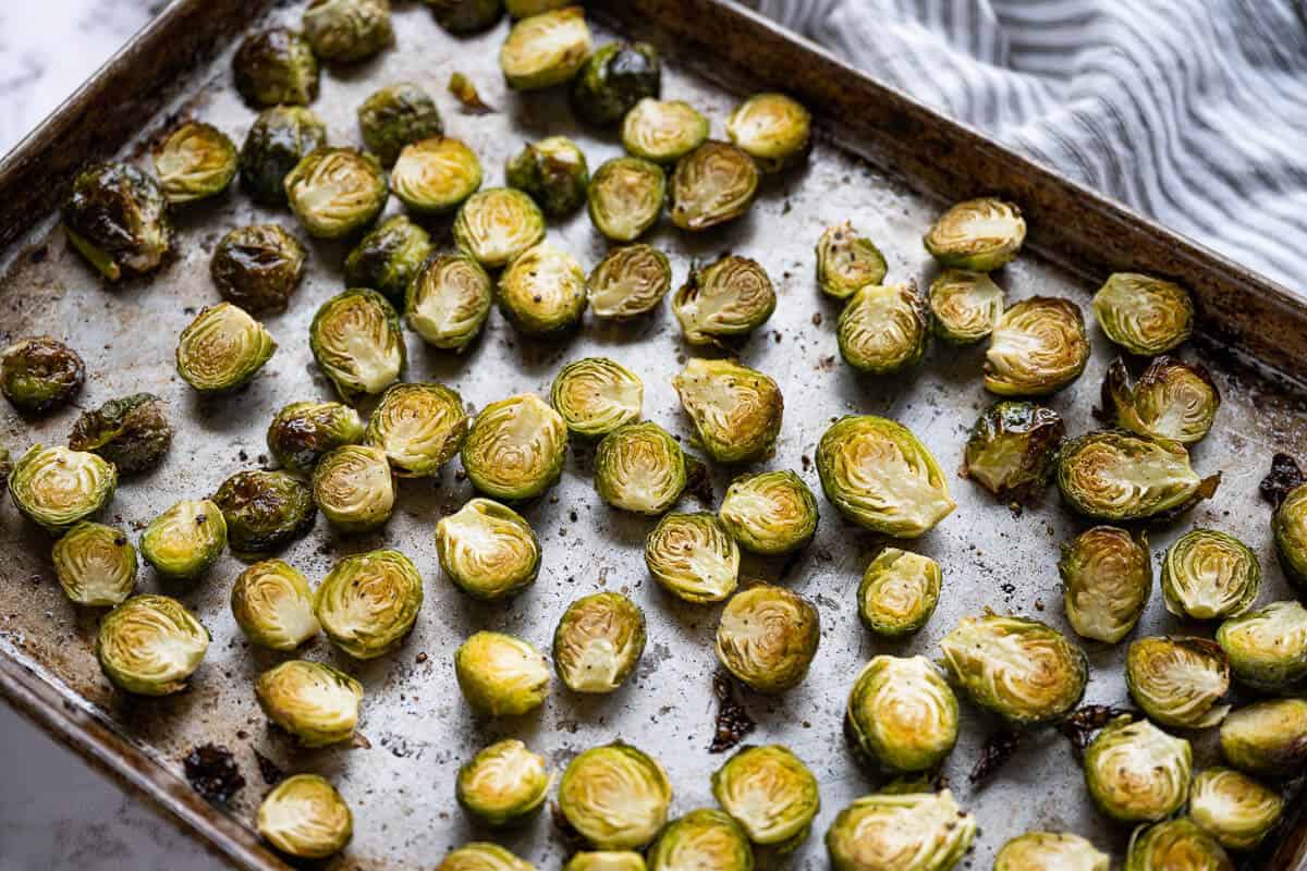 Roasted brussels sprouts on a sheet pan.
