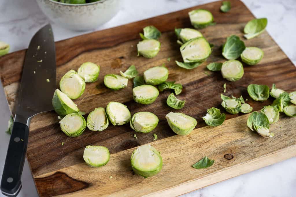 sliced raw brussels sprouts on a cutting board