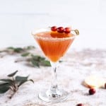 apple cider sangria (non-alcoholic) in a martini glass rimmed in sugar