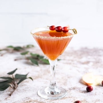 apple cider sangria (non-alcoholic) in a martini glass rimmed in sugar