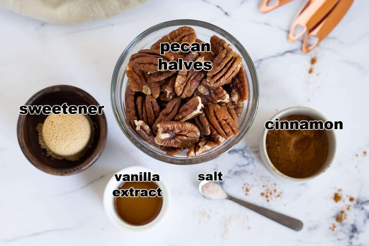 Ingredients for Keto Candied pecans: pecan halves, sweetener, vanilla extract, cinnamon, and salt.