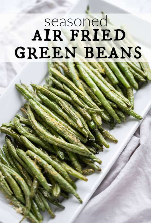 Air fried green beans with seasonings on a rectangle white platter. via @artfrommytable