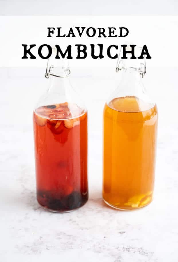 Two glass swing-top bottles filled with flavored kombucha. One is berry flavored, the other is ginger flavored. via @artfrommytable
