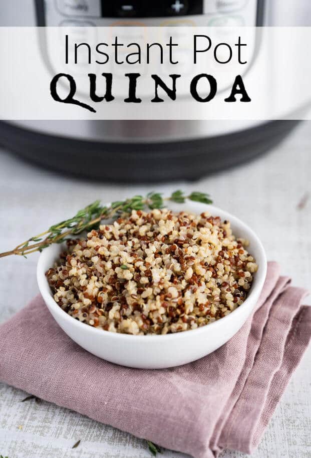 Cooked quinoa in a white serving dish in front of a pressure cooker. via @artfrommytable