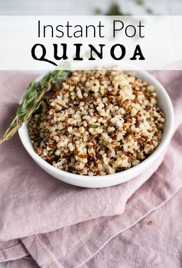 Tri-color quinoa in a round white serving bowl garnished with a sprig of fresh thyme. via @artfrommytable