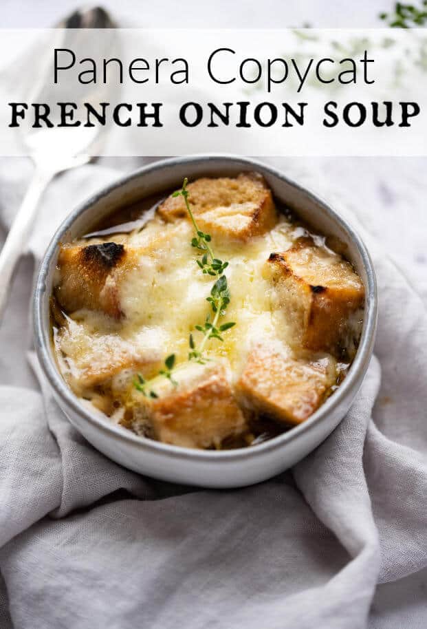 Bowl of French Onion Soup topped with crusty croutons and melted gruyere cheese, garnished with a sprig of thyme. via @artfrommytable