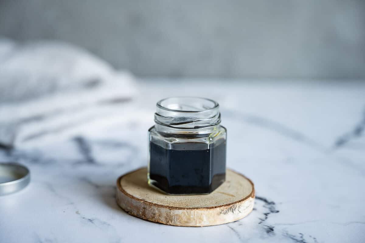 Glass jar full of balsamic reduction.