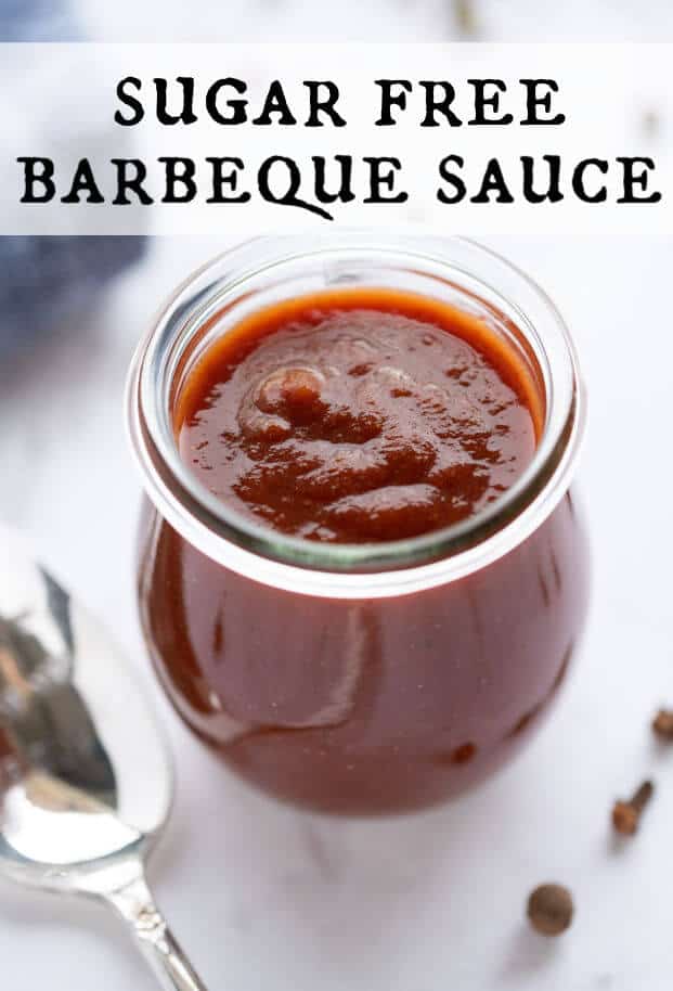Thick homemade sugar free barbeque sauce in a glass jar with a spoon alongside it. via @artfrommytable
