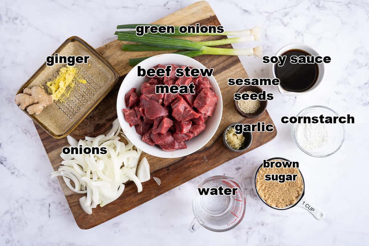Ingredients for mongolian beef: stew meat, onions, green onions, ginger, soy sauce, sesame seeds, garlic, cornstarch, and brown sugar.