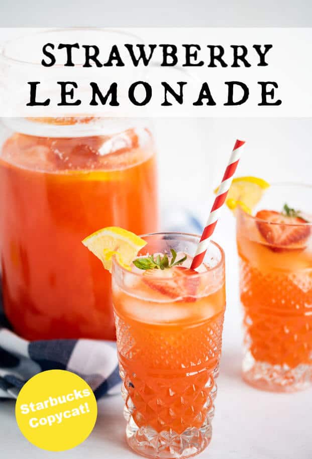 Glass of homemade strawberry lemonade with a red and white striped straw, and garnished with a strawberry slice and a lemon wedge. Behind the glass is another glass and a pitcher of the remaining lemonade. via @artfrommytable