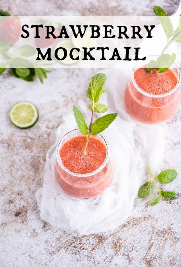 Clear sugar rimmed glass filled with a blended strawberry drink, garnished with fresh mint and a slice of lime. via @artfrommytable