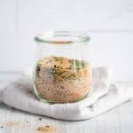 Homemade Seasoned Salt in a glass Weck jar, sitting on top of a gray folded towel.