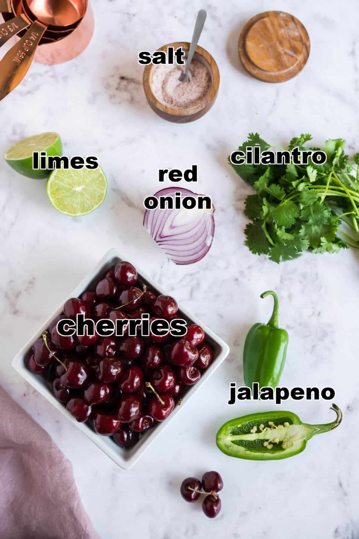 Ingredients for cherry salsa: cherries, red onion, jalapeno, lime, cilantro and salt