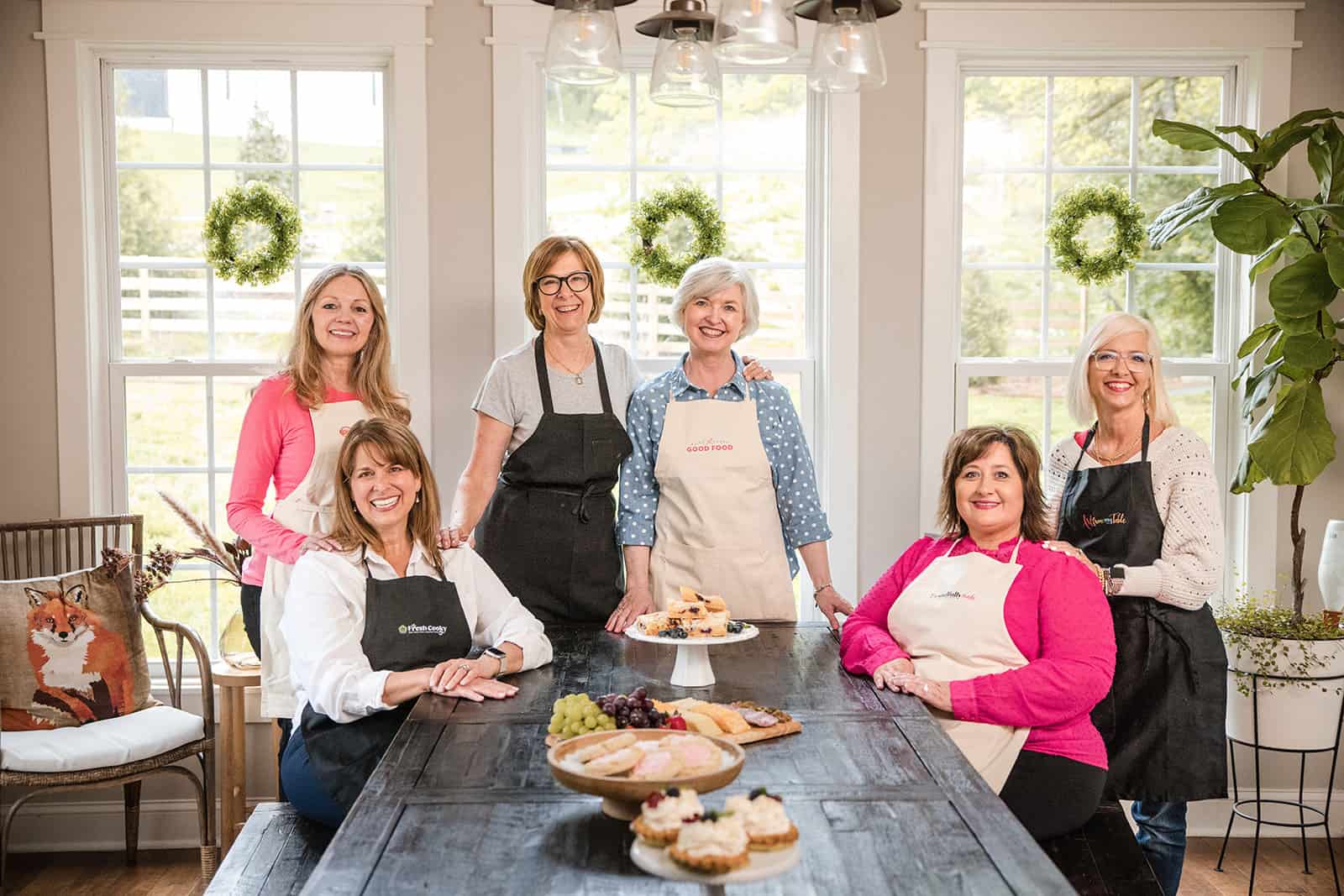 image of me and my blogging mastermind group at a farmhouse table.