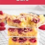 Stack of 4 raspberry bars on a baking rack.