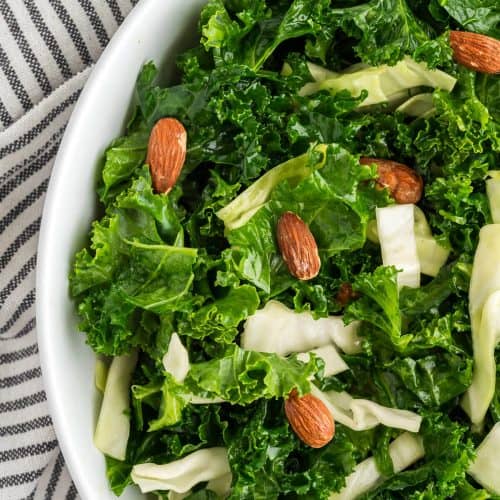 overhead view showing half the bowl full of homemade Kale Crunch Salad.