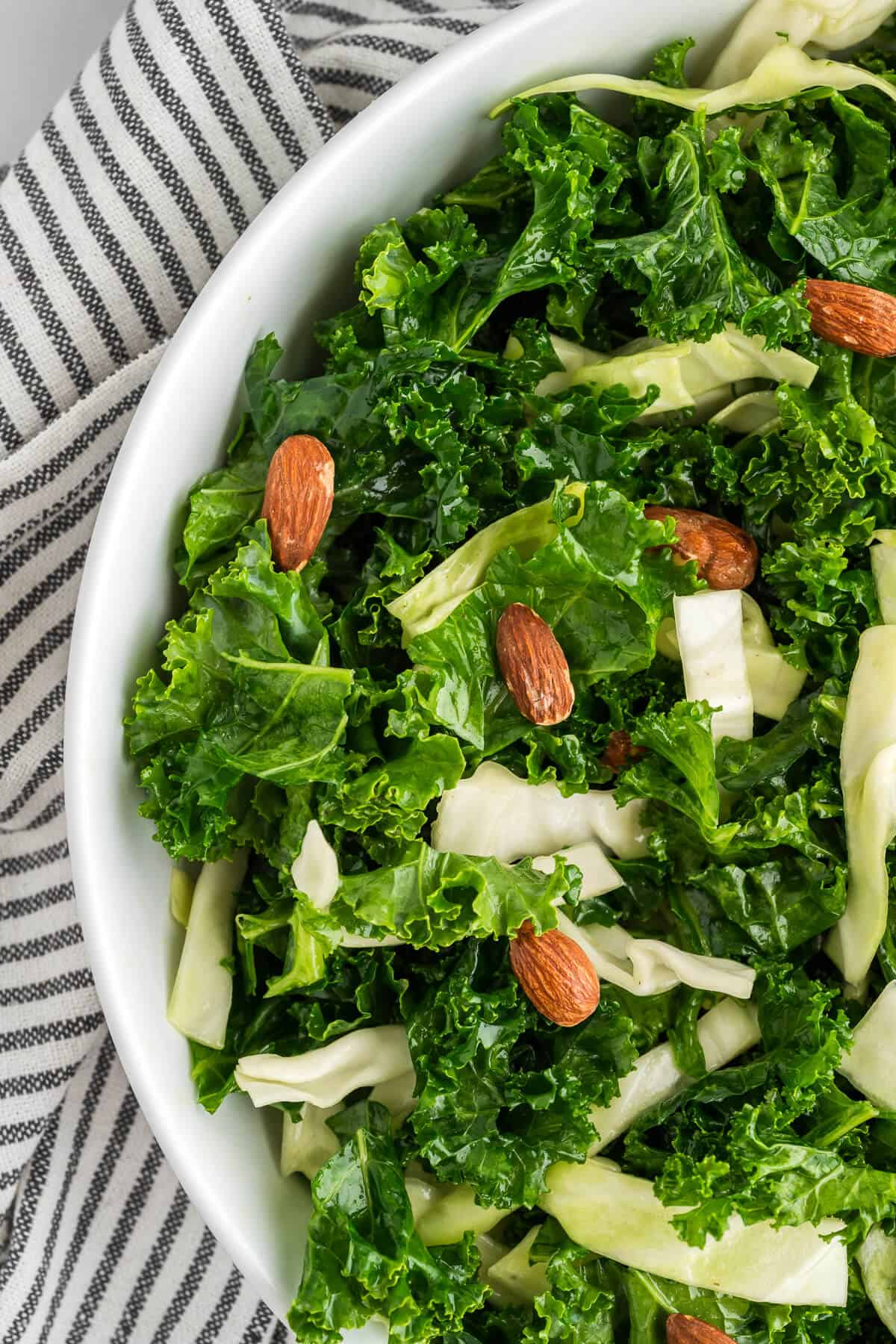 overhead view showing half the bowl full of homemade Kale Crunch Salad. 