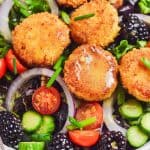 Crispy goat cheese topped on a bed of mixed greens, onions, sliced cucumbers, blackberries and cherry tomatoes. It's drizzled with Dijon Vinaigrette.
