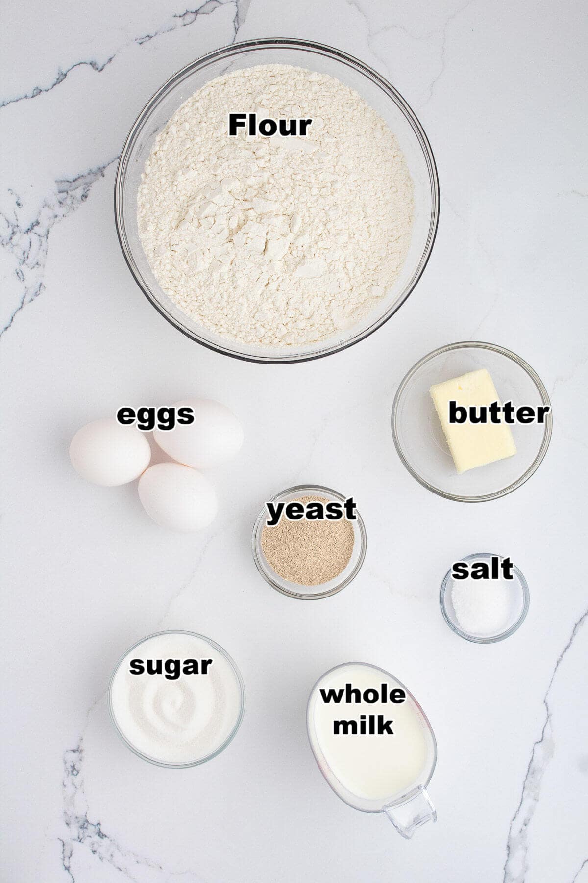 Ingredients to make crescent rolls: flour, eggs, yeast, butter, sugar, milk, and salt.