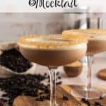 Espresso martini mocktail in a coupe glass with a golden raw sugar rim and frothy top, styled with scattered coffee beans and a bag of whole beans in the background. Text overlay reads: Espresso Martini Mocktail