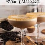 Espresso martini mocktail in a coupe glass with a golden raw sugar rim and frothy top, styled with scattered coffee beans and a bag of whole beans in the background. Text overlay reads: Espresso Martini Non Alcoholic.