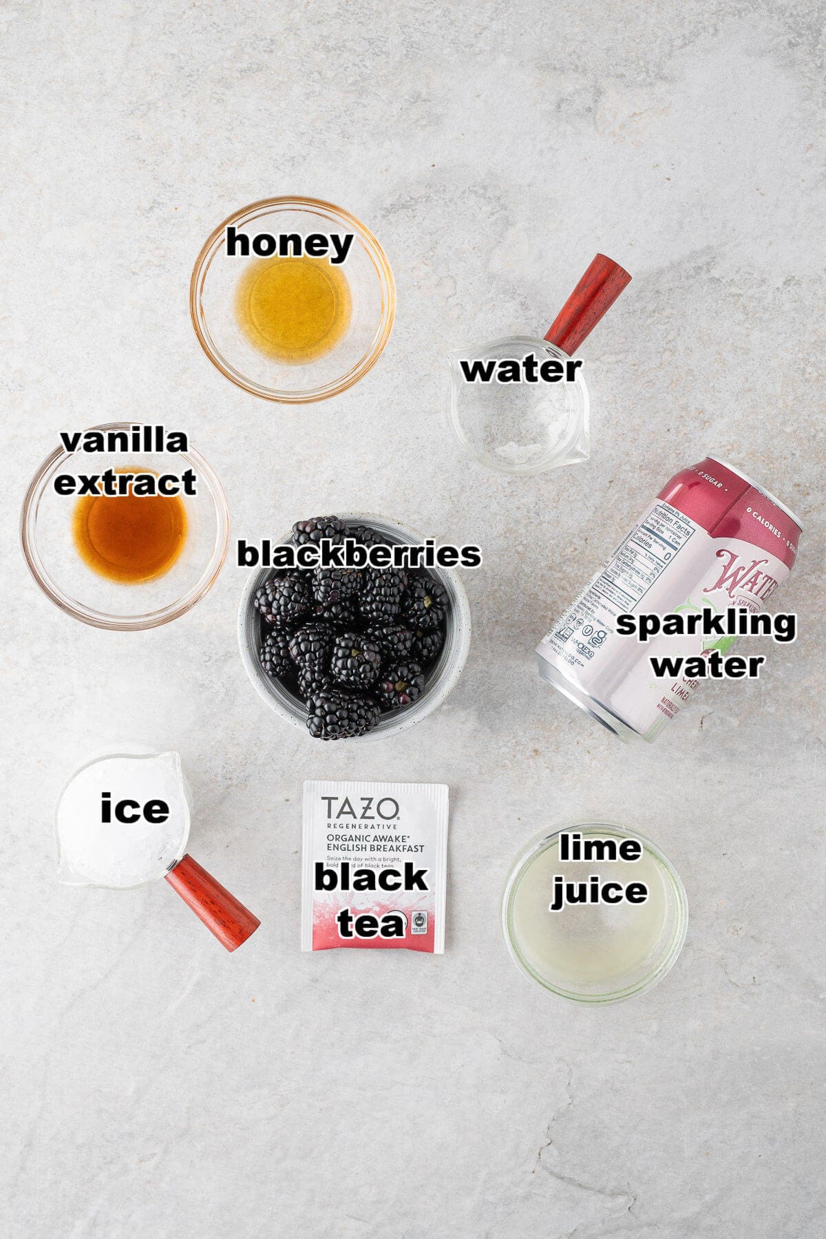 Ingredients to make a Blackberry Mocktail: blackberries, honey, sugar, water, vanilla extract, black tea, lime juice, sparkling water and crushed ice.