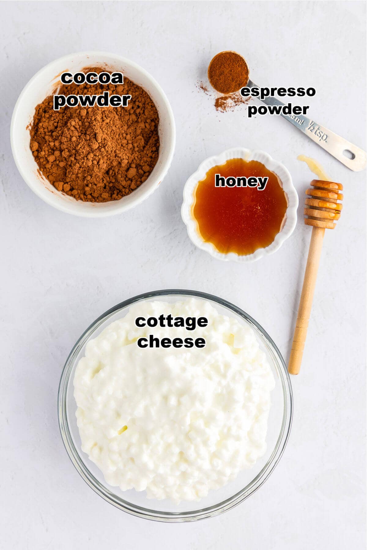 Ingredients to make Cottage Cheese Chocolate Mousse: Cocoa powder, espresso powder, honey and cottage cheese.